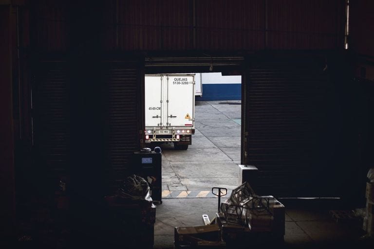 Truck leaving a dock with automotive freight